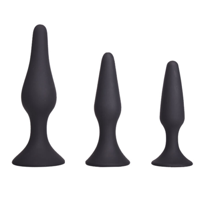 a set of three black silicone anal plugs of varying sizes. Each plug has a tapered design for easy insertion and a flared base for safety and comfort. The smooth, sleek surface ensures a pleasant experience for users of all experience levels, making this set suitable for gradual progression in size and intensity.