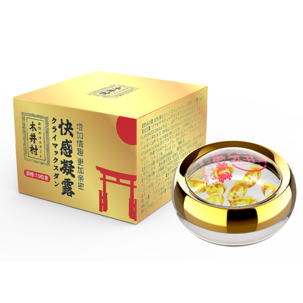 a product from the Kijimura brand called Climax Gel. The packaging box has a gold design with red and black text and patterns, reflecting a traditional Japanese style. The front of the box displays the brand logo and product name. Next to the box, there is a round, transparent container holding the gel, with a gold lid, giving it a very refined and high-end appearance. Inside the container, you can see the clear gel with hints of red and yellow details. The overall design looks luxurious and elegant, highlighting the product's high quality and effectiveness.