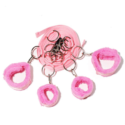 a set of pink soft cuffs connected by a pink strap, designed for restraint play in BDSM activities. The cuffs are padded for comfort and secured with metal rings and clasps, allowing for adjustable and secure restraint. This set is typically used to limit the movement of wrists and ankles during role-playing scenarios.