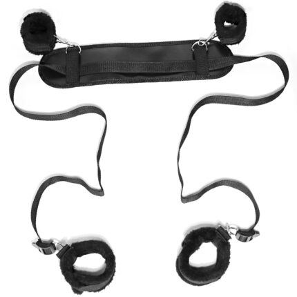 a black restraint system for bondage play. The set includes padded cuffs for both wrists and ankles, connected by adjustable straps. The central padded bar ensures comfortable restraint during use.