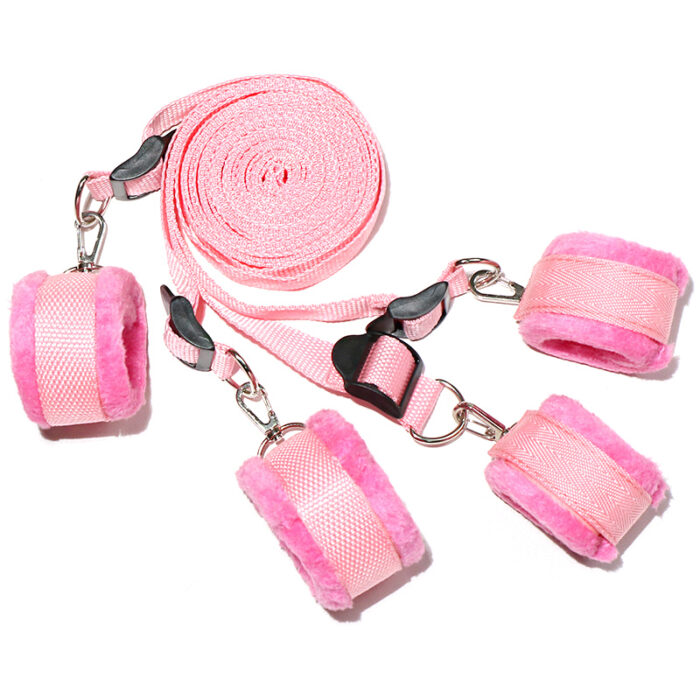 a set of pink bondage restraints. The set includes four soft, plush-lined cuffs for the wrists and ankles, connected by adjustable straps. The pink color adds a playful and gentle touch to the set, ensuring both comfort and security during intimate activities.