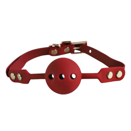 a red ball gag with adjustable straps and metal studs, designed for use in bondage and BDSM activities. The ball gag has ventilation holes for safety and comfort.