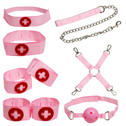 a set of pink bondage accessories, including a collar, wrist and ankle cuffs, a ball gag, a leash with a chain, and connecting straps. Each item is adorned with a red cross emblem, adding a distinctive touch to the set. These accessories are designed for sensory play and BDSM activities, offering a playful and intimate experience.