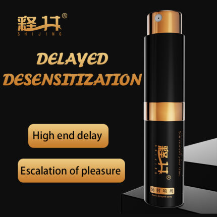 a SHIJING brand male delay spray. The packaging and spray bottle have a black and gold design, giving it a very high-end and stylish appearance. The front of the box has the tagline “DELAYED DESENSITIZATION” and the phrases “High end delay” and “Escalation of pleasure,” highlighting the product's premium delay effect and pleasure enhancement function. The spray bottle is elegantly designed with a black body and gold details, with the brand logo printed on it. The overall design conveys the product's effectiveness and luxury feel, making it suitable for male users who seek quality and performance.