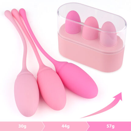 The image displays a set of three pink Kegel exercise weights of varying sizes and weights (30g, 44g, and 57g). The weights are designed to help strengthen pelvic floor muscles. The set comes with a sleek storage case to keep the weights organized and clean. Each weight has a smooth, ergonomic design for comfortable use.