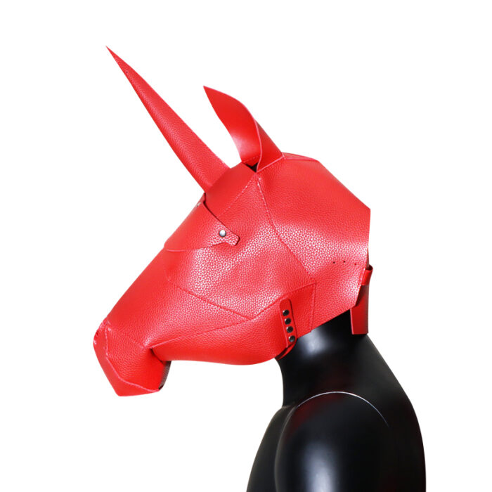 a red leather unicorn mask designed for cosplay or BDSM role-playing. The mask features a prominent horn at the top, pointy ears, and detailed facial contours to resemble a unicorn. It is worn over the head, covering the entire face, and is often used to add a fantastical element to role-playing activities.