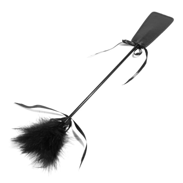 a black BDSM tickler and paddle combo. The tickler features soft feathers on one end for gentle, teasing sensations, while the other end has a small leather paddle for light spanking. This dual-purpose accessory is designed for sensory play and adding variety to intimate experiences.