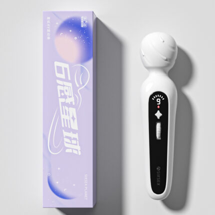 A white handheld massager with a rounded head and black control panel, shown next to its purple box packaging. The packaging features white text and an abstract design.