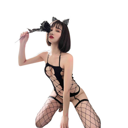 The image shows a model wearing a black fishnet bodysuit with multiple cutouts, paired with matching fishnet stockings. The outfit has a bold, provocative design, and the model is posing with a black rose, adding a touch of elegance and mystery to the overall look. She is also wearing cat ear headbands, which complement the playful yet seductive theme of the attire.