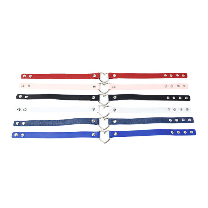 a collection of adjustable straps in various colors, including red, black, pink, white, and blue. Each strap is equipped with metal studs for adjustment and a central metal heart-shaped ring for attachment or decoration. These straps are typically used as accessories for fashion or restraint purposes in BDSM activities, allowing users to secure or decorate various parts of the body.