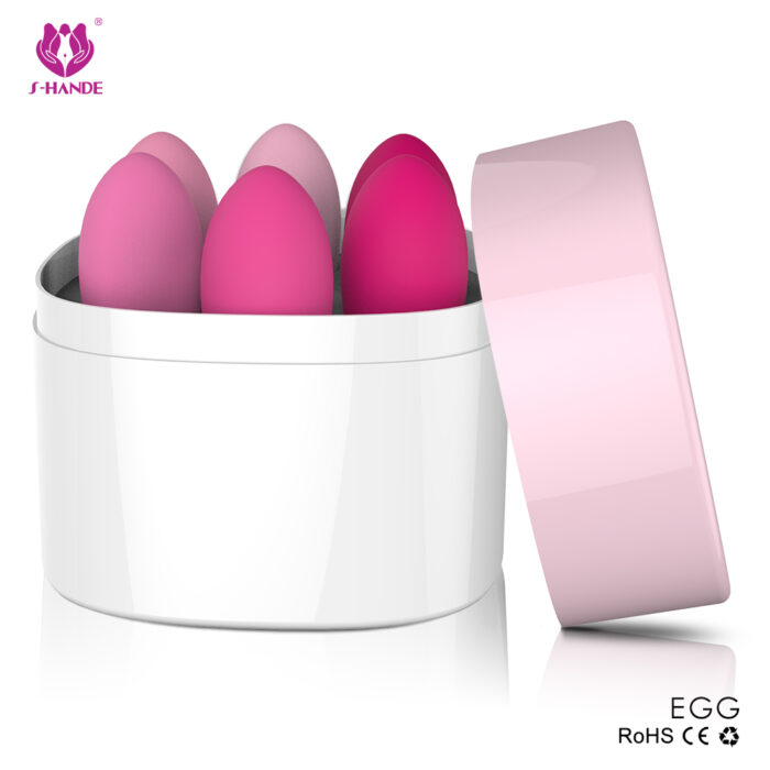 a set of pink egg-shaped devices housed in a white container with a pink lid. These devices are likely to be Kegel exercise weights or similar intimate products designed for women's health and wellness.