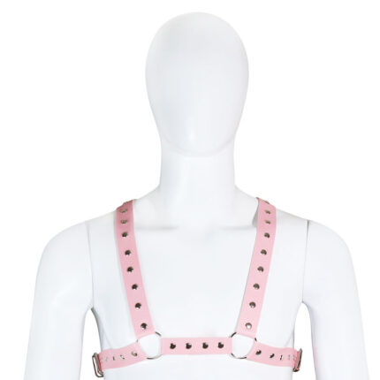 a pink leather harness with metal studs, worn on a mannequin. The harness has adjustable straps and heart-shaped cutouts, adding a playful and stylish element to the design. It is designed for both aesthetic and functional purposes in BDSM activities, providing a fashionable and secure accessory for bondage play.